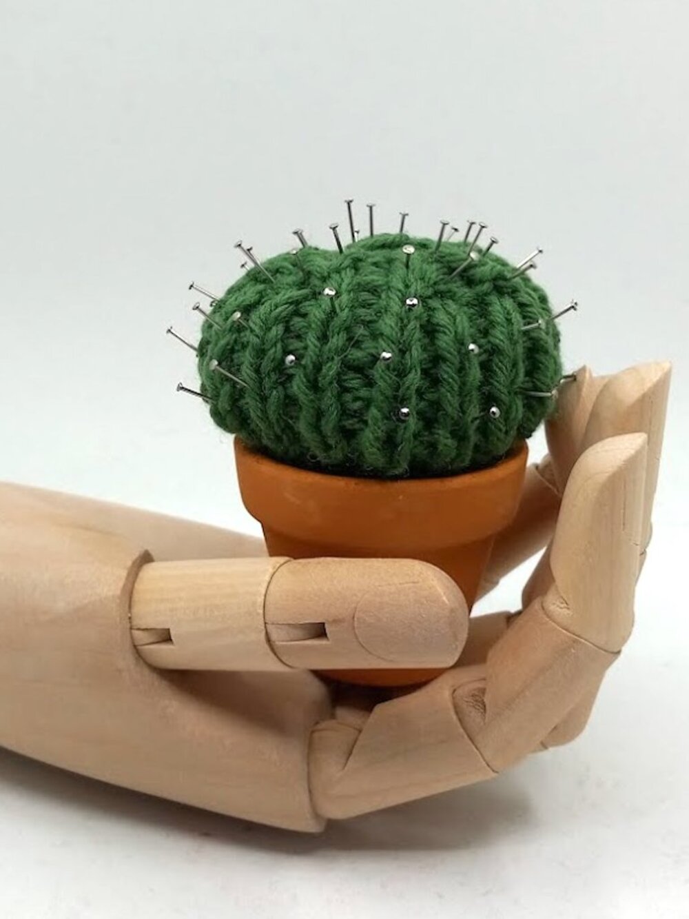 Mini knitted cactus in clay pot